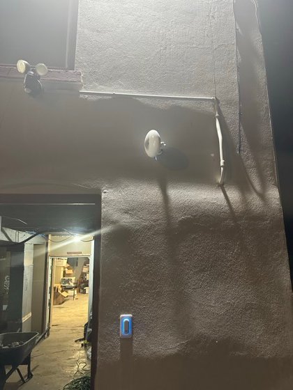A point-to-point wireless bridge beaming internet across the street to this building, with the door access reader mounted on the entry below.