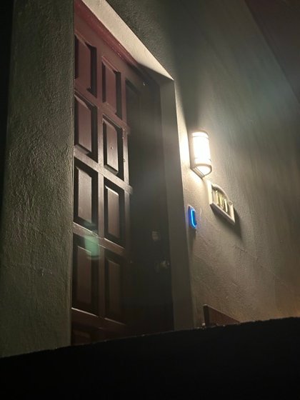Reader at the entry, lit for a night approach and mounted clear of the door swing.