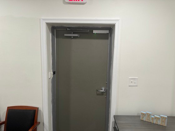 The lock hardware at the head of the door &mdash; magnetic lock with a status LED, and a closer that returns the door to a secure position every time.