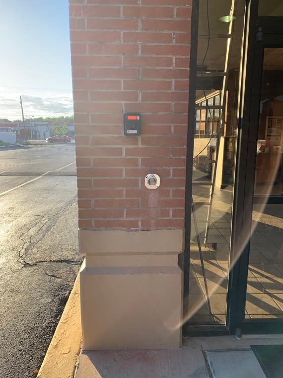Card reader mounted beside a storefront entry door