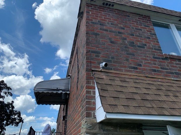 Exterior camera set high on the corner, covering the approach to the building.