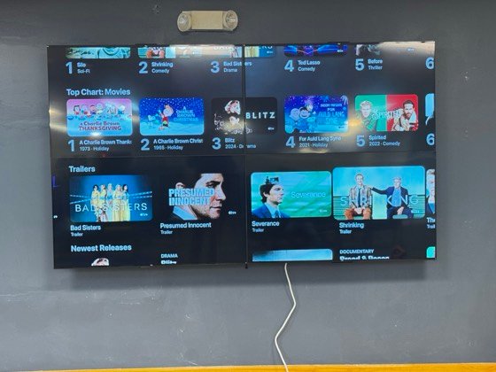 Four panels driven as one display &mdash; content carries across all of them as a single canvas.